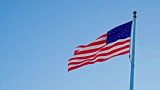 Flag of the USA. National waving flag united states on blue sky. Independence day. Patriotic symbol. American Flag for Memorial Day or 4th