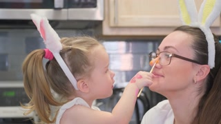 A truly delightful moment captured of a mother and daughter joyfully enjoying Easter festivities together