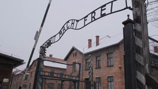Entrance gate with the sign arbeit macht frei at the auschwitz-birkenau memorial and museum
