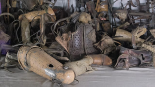 Large pile of prosthetic limbs and medical corsets from victims of the auschwitz concentration camp