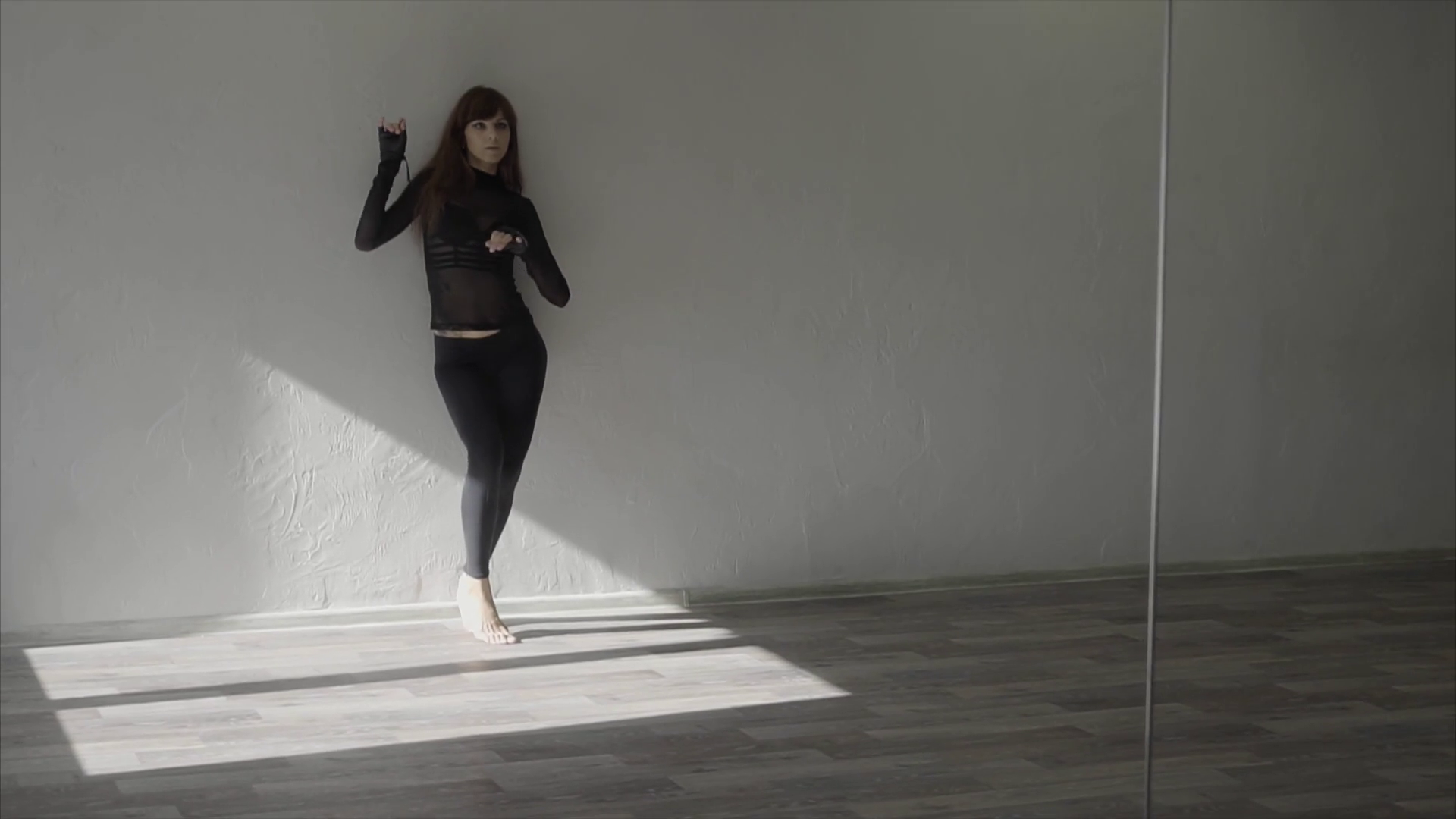 Slow motion shot of a beautiful female dancer dancing in the studio