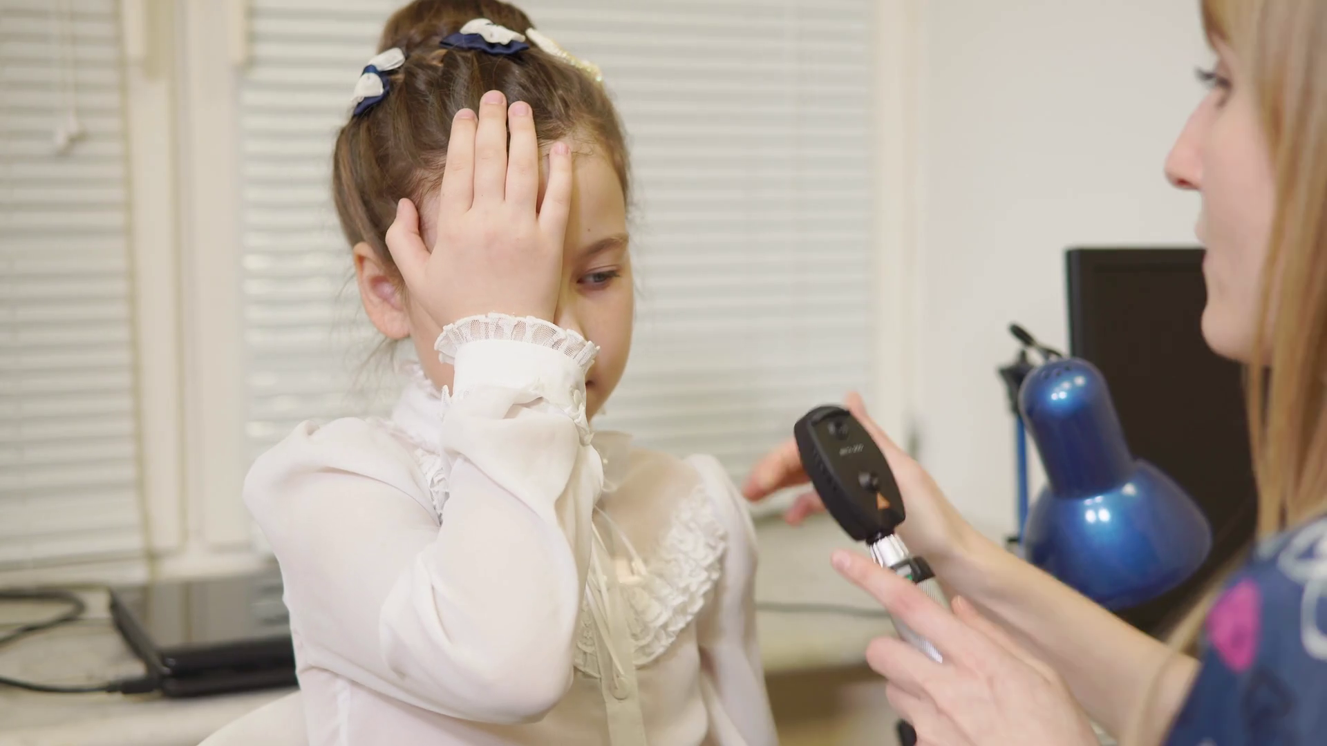 a professional ophthalmologist checks the eyesight of the child, the