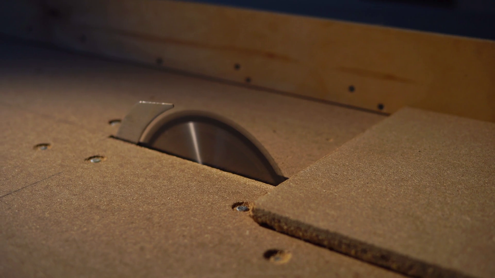 close up shot of the man's hands, who cuts a piece of wood chipboard, a