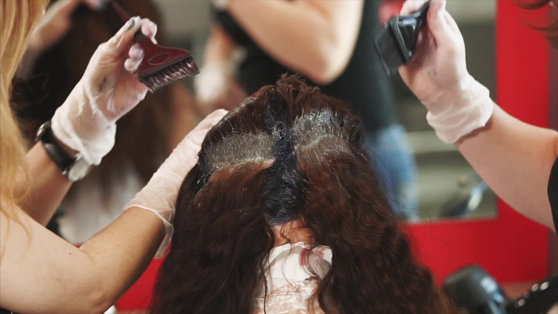 Hairdressers coloring hair in studio. Process of coloring. Hairdressers