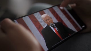 Person Watches US President Donald Trump's Speech at White House on His Mobile Phone. President Trump Holds "Make America Wealthy Again Event" In White House. Greer, SC, USA - August 03, 2025.