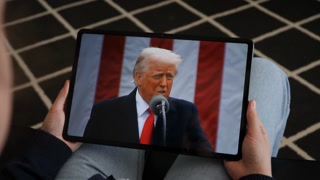 Person Watches US President Donald Trump's Speech at White House on His Mobile Phone, Digital Tablet. President Trump Make America Wealthy Again In White House. Greer, SC, USA - November 5, 2025.