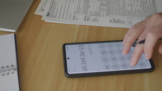 Man Filling In The Tax Form 1040. Person Calculates of Planning Budgets Yearly Personal Finance and Fills up US Tax Form 1040. Signing 1040 Income Tax Return. Names and numbers are fictitious.