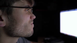 Focused male trader analyzing cryptocurrency market trends on computer screen, showcasing intense concentration and engagement in digital trading environment, capturing the essence of modern finance