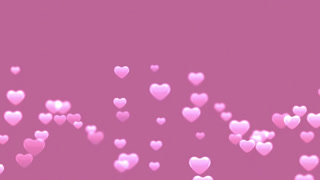 Soft pink hearts floating upwards on a pink background for valentines day wedding anniversaries and romantic concepts of love and affection