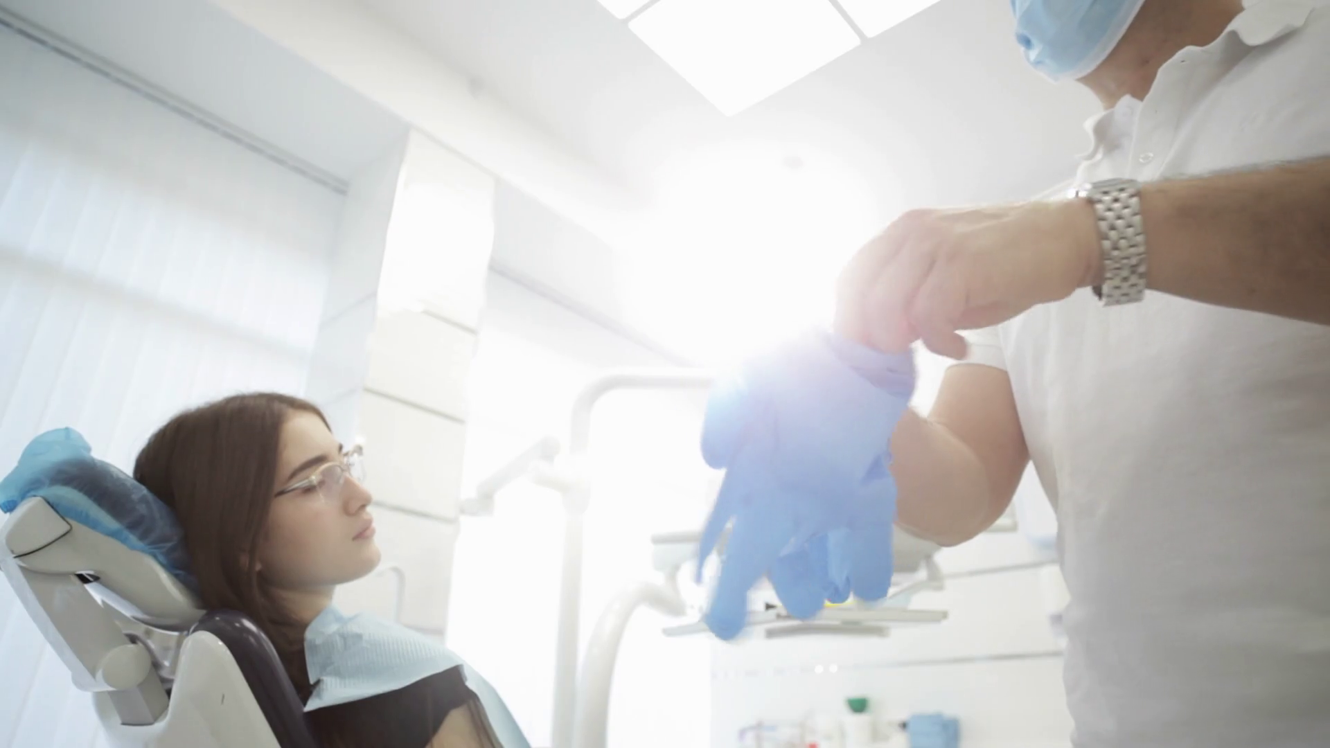 Male Dentist Putting On Gloves With Patient Stock Footage SBV312021720 Storyblocks