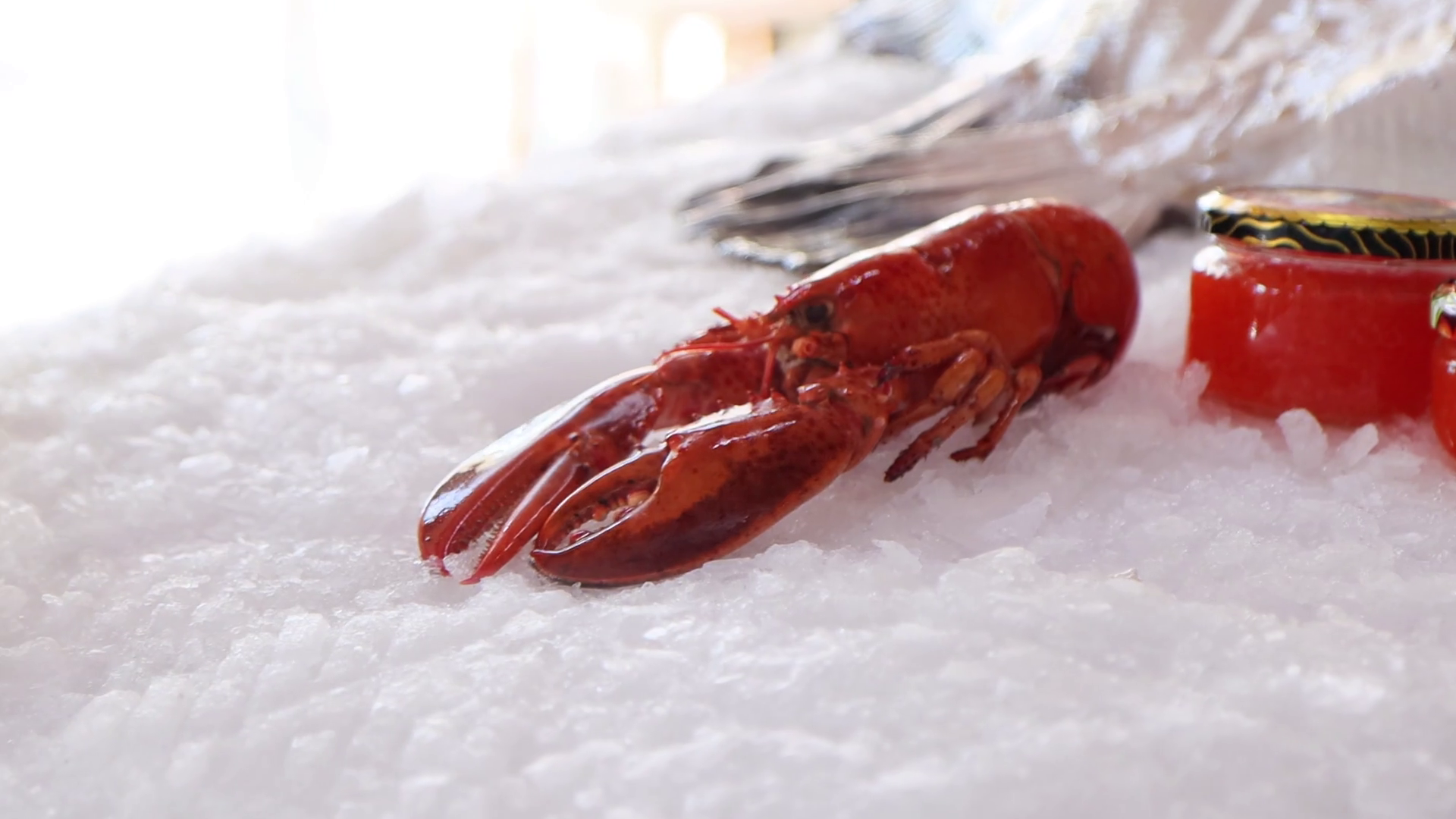 Red crayfish on ice. Cooked chilled crayfish. Fish roe in jar. Stock