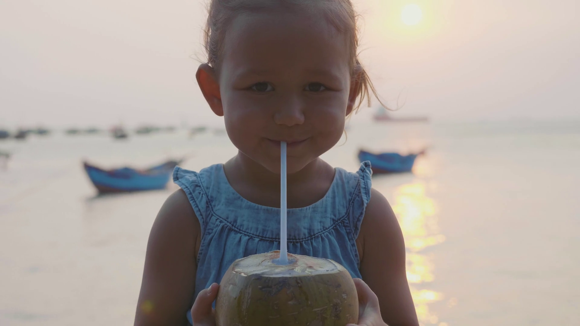 Little Girl Drinks Coconut Water At Seafront Stock Footage SBV
