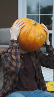 man with a pumpkin on his head