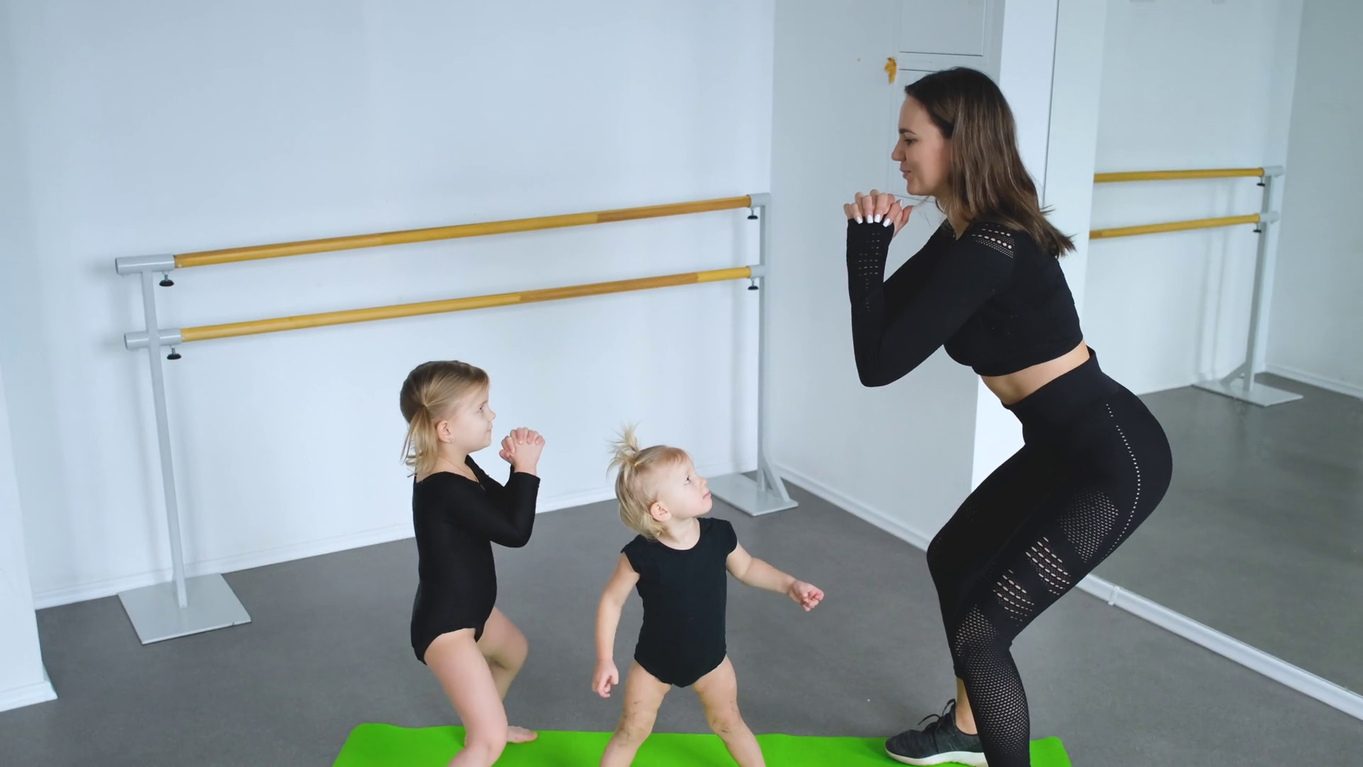 female gym teacher with girls squats Stock Video Footage 0013 SBV