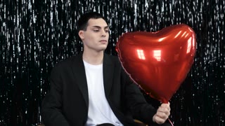 portrait of a Tatar man with a heart balloon and the inscription no on it