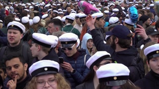 HELSINKI, FINLAND - APR 30, 2022: A huge crowd of students in traditional caps celebrate May Labor Day (Vappu) near Havis Amanda fountain at the Trade square