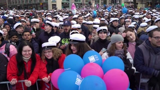HELSINKI, FINLAND - APR 30, 2022: A huge crowd of students in traditional caps celebrate May Labor Day (Vappu) near Havis Amanda fountain at the Trade square