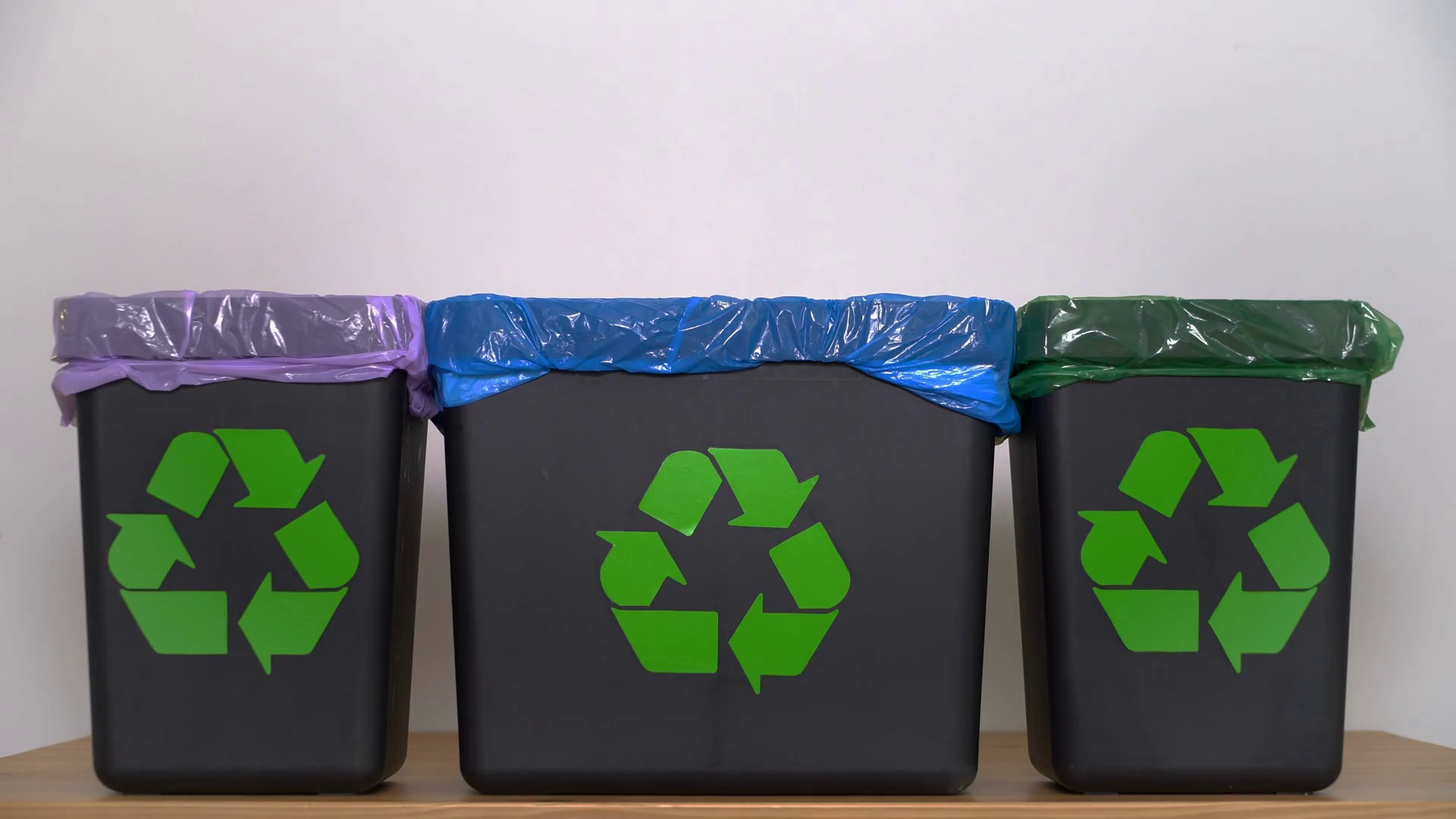 Distribution of waste for recycling at home. A woman's hand puts