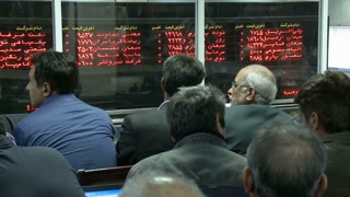 TEHRAN STOCK EXCHANGE, IRAN - 2013: Business people trade stocks. (TSE) is Iran's largest stock exchange with a combined market capitalization of over US 104 billion