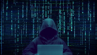 Anonymous Hacker in Hoodie. Typing on Laptop Computer. Blue Digital Matrix Code Rain. Cyber Security Concept. Glitch Effect Background.