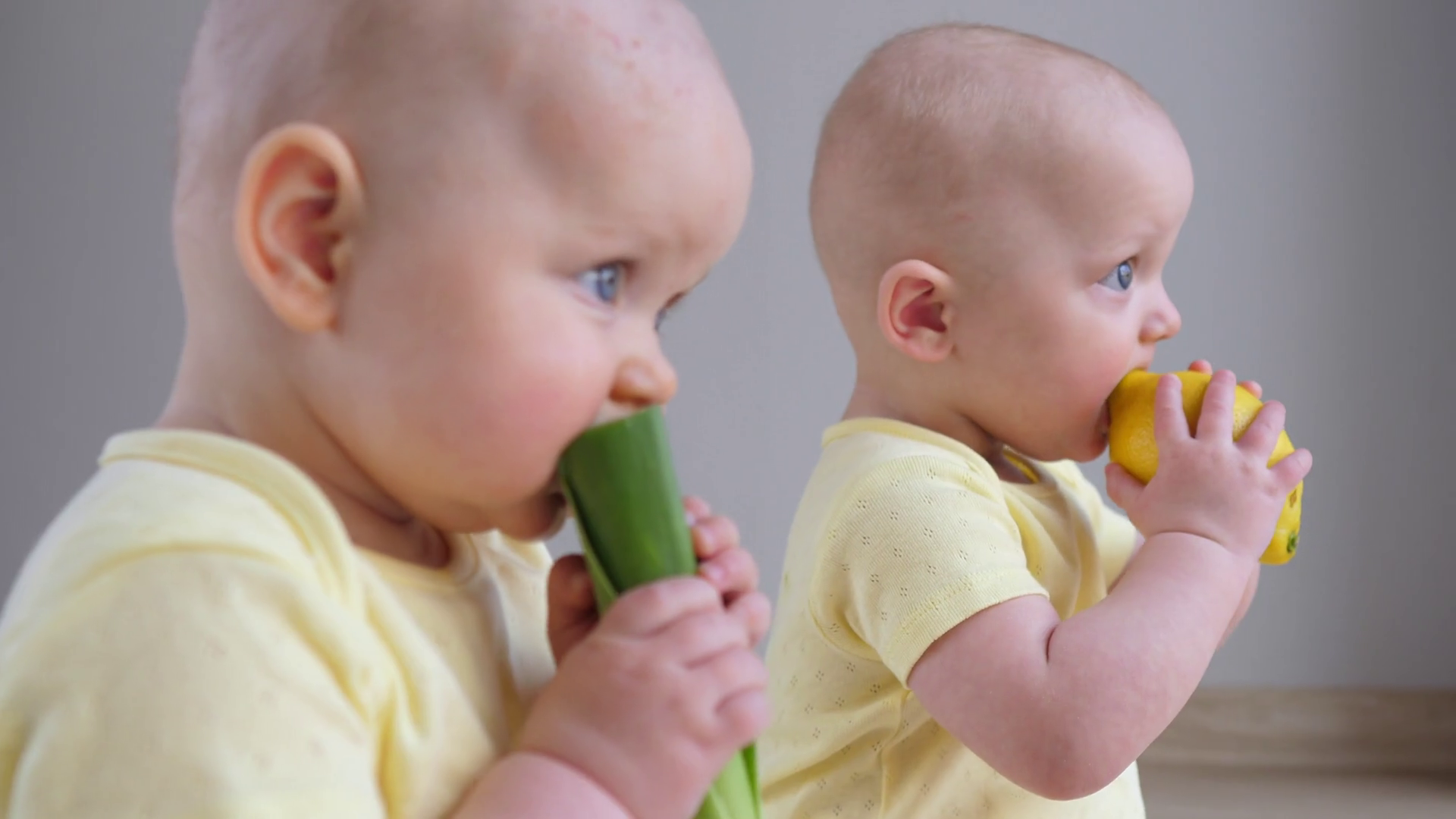 Two Adorable Twin Babies Eating Fresh Fruits Stock Footage SBV