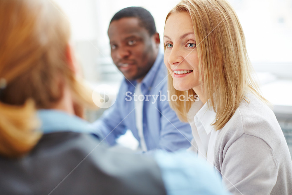 Smiling Businesswoman Between Her Co-workers