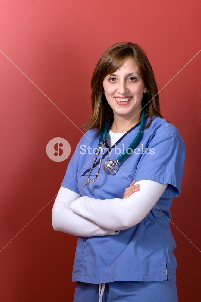 A young woman doctor with her arms crossed isolated over a red background