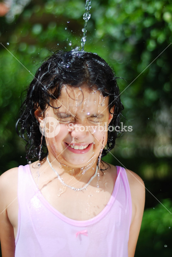 Cute girl is taking a shower outdoor with expression on face Royalty