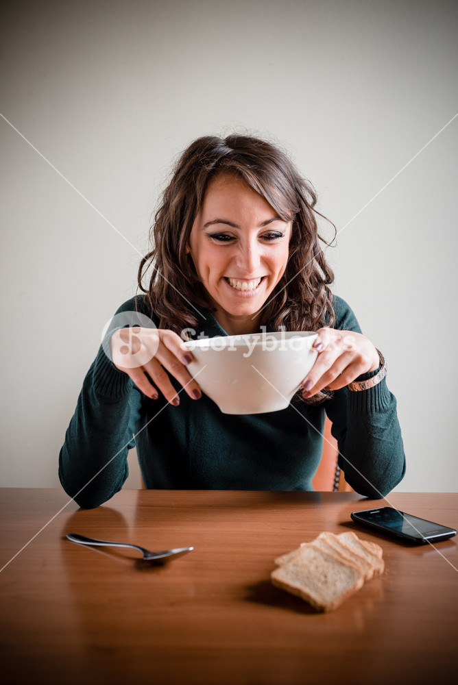 beautiful woman having breakfast at home