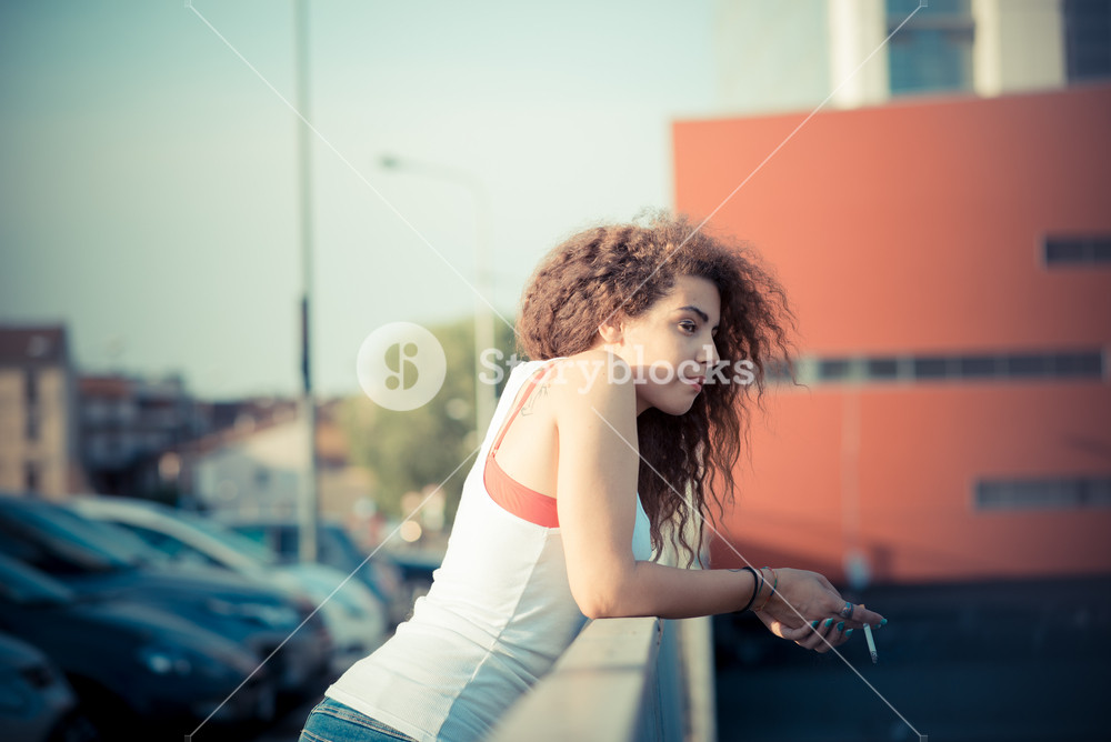 Stylish woman with curly hair enjoying city vibes