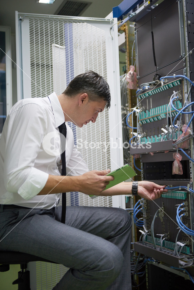 Network engineer working in server room RoyaltyFree Stock Image
